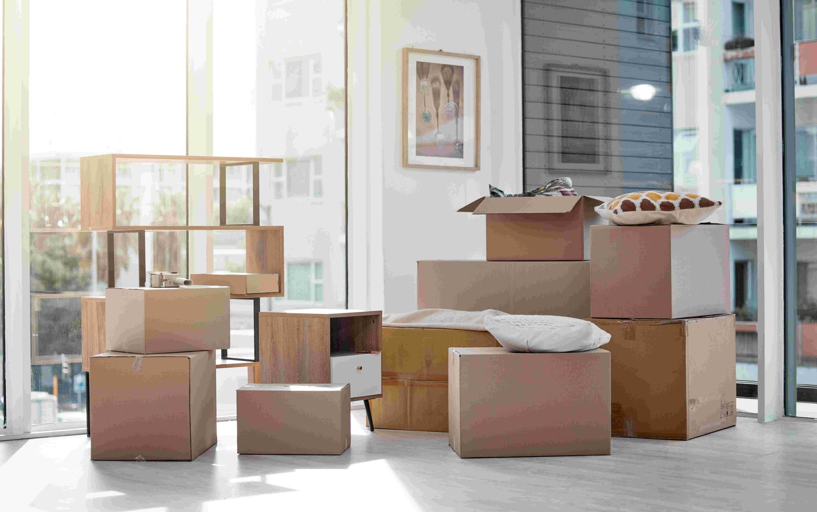 A moving truck parked with boxes and household items ready for pickup